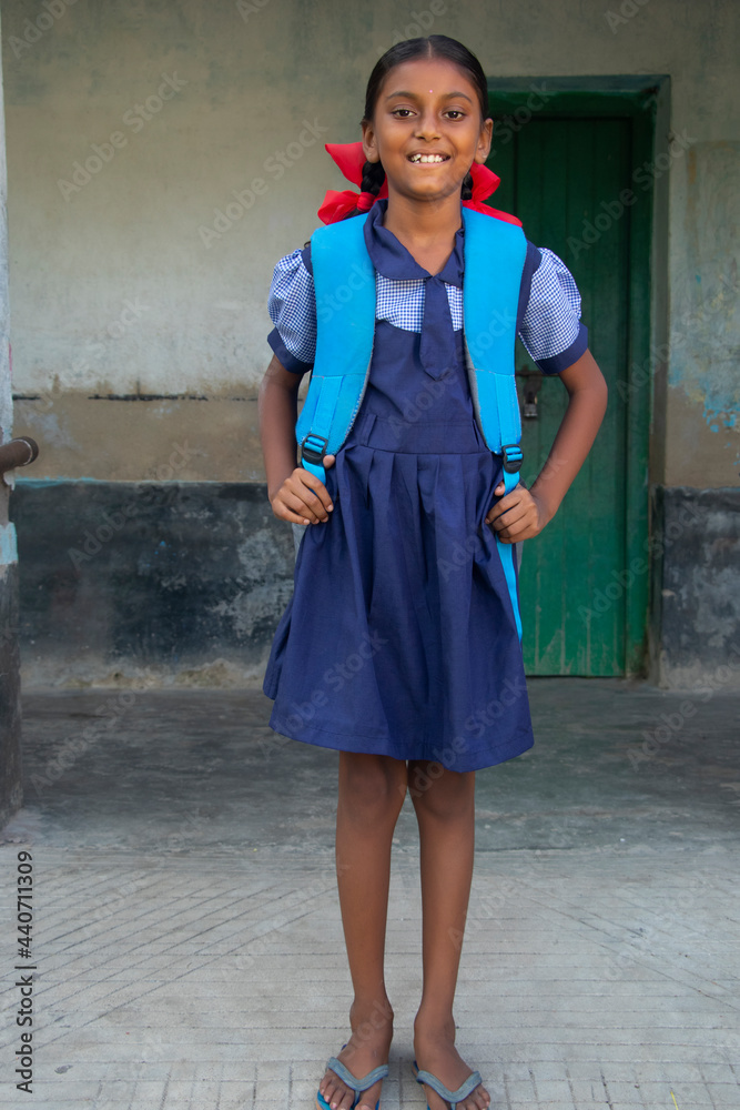 An Indian Rural School Girl wearing School Uniform Standing in school Stock  写真 | Adobe Stock