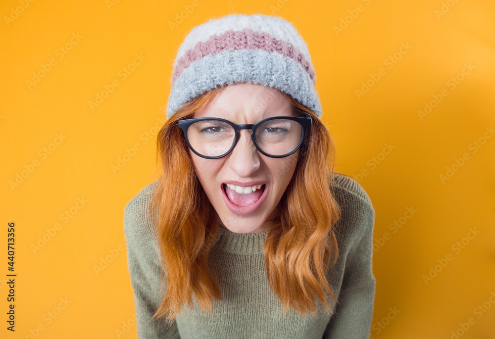 Rage woman looking at camera and screaming, isolated on yellow background. Frustrated female person Rage woman looking at camera and screaming, isolated on yellow background. Frustrated female person