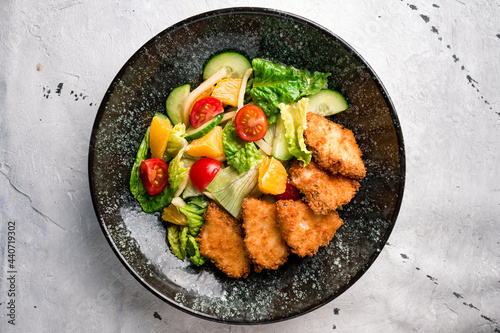 Colorful vegetable dish with mixed orange, nuggets, lettuce and tomatoes. Beautiful view of restaurant healthy food
