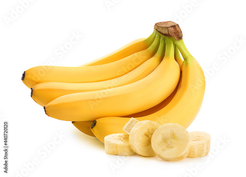 Delicious ripe bananas and pieces on white background
