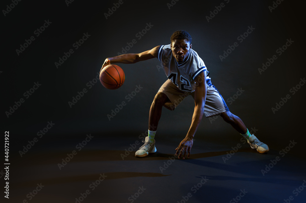 Basketball player with ball, practicing in action