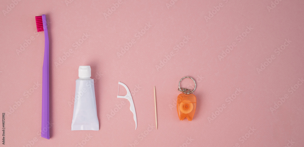 Oral hygiene products on a pink background. Toothbrush toothpaste dental floss and toothpick. Copy space. Oral hygiene products on a pink background. Toothbrush toothpaste dental floss and toothpick. Copy space.