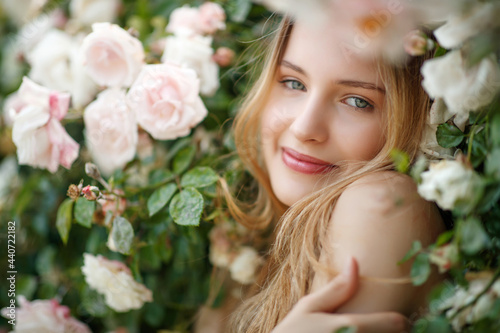 Beautiful young woman smells a rose flower. High quality photo