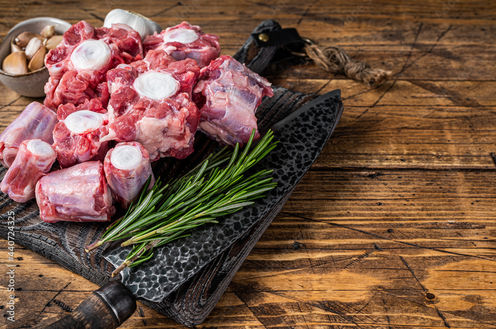 Raw beef Oxtail cut Meat on wooden cutting board with knife. wooden background. Top view. Copy space - obrazy, fototapety, plakaty 