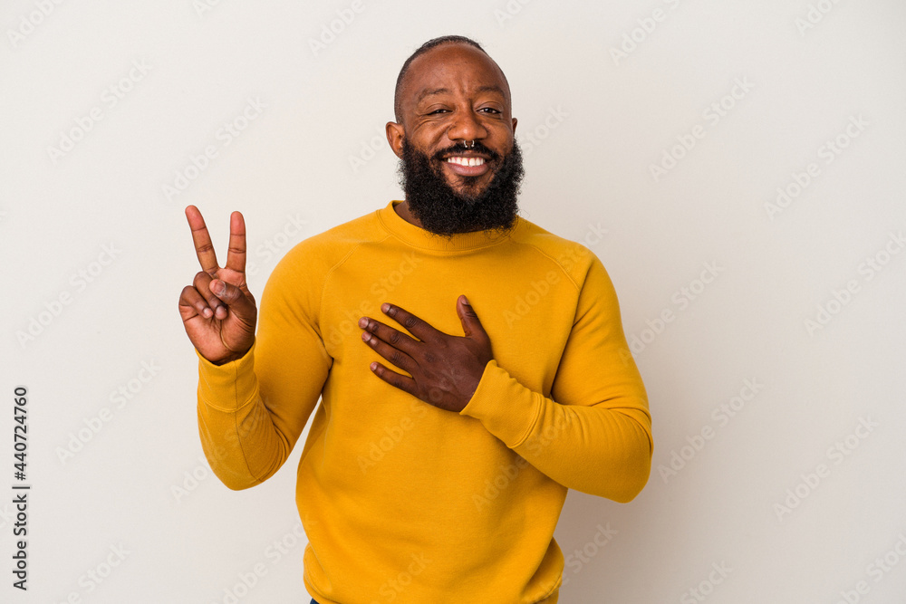 African american man with beard isolated on pink background taking an oath, putting hand on chest.