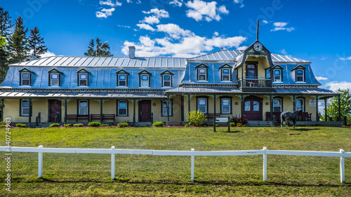 View on the Port Daniel city hall in Gaspesie (Quebec, Canada). Typical french canadian historic architetcure with tin roof. photo