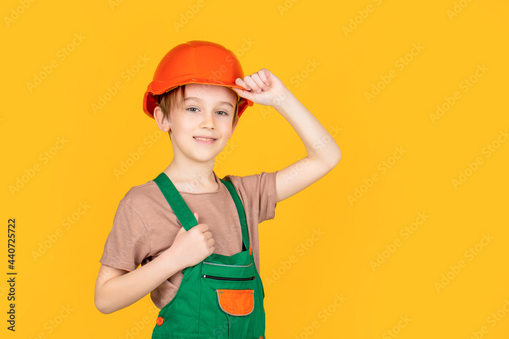 Little builder in helmet. Child dressed as a workman builder. Little boy wearing helmet. Portrait little builder in hardhats. Child building helmet, hard hat