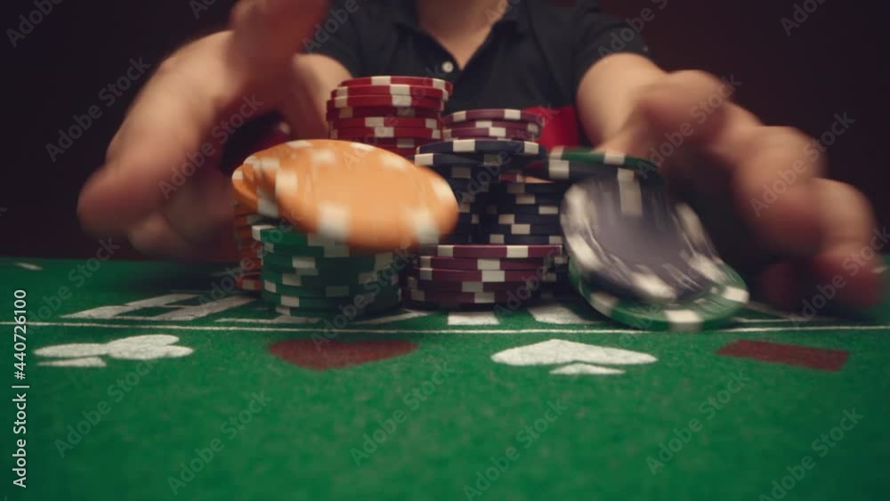 Male player betting all chips in while playing in casino, close up Male player betting all chips in while playing in casino, close up