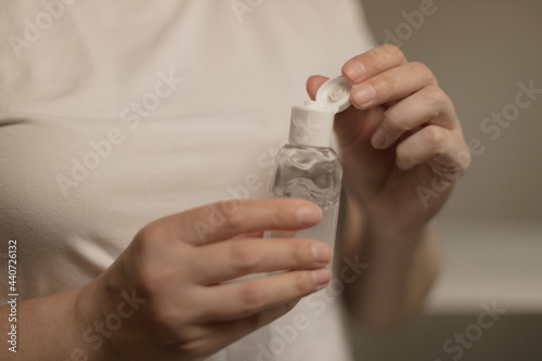 Caucasian woman using antibacterial antiseptic gel to clean her hands, hygiene concept to protect against pandemic coronavirus