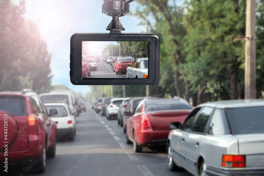 Modern dashboard camera mounted in car, view of road during driving