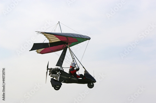 Ultralight airplane flying in a blue sky 