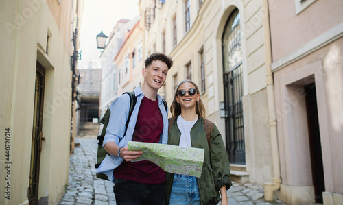 Young couple travelers with map in city on holiday, sightseeing. © Halfpoint