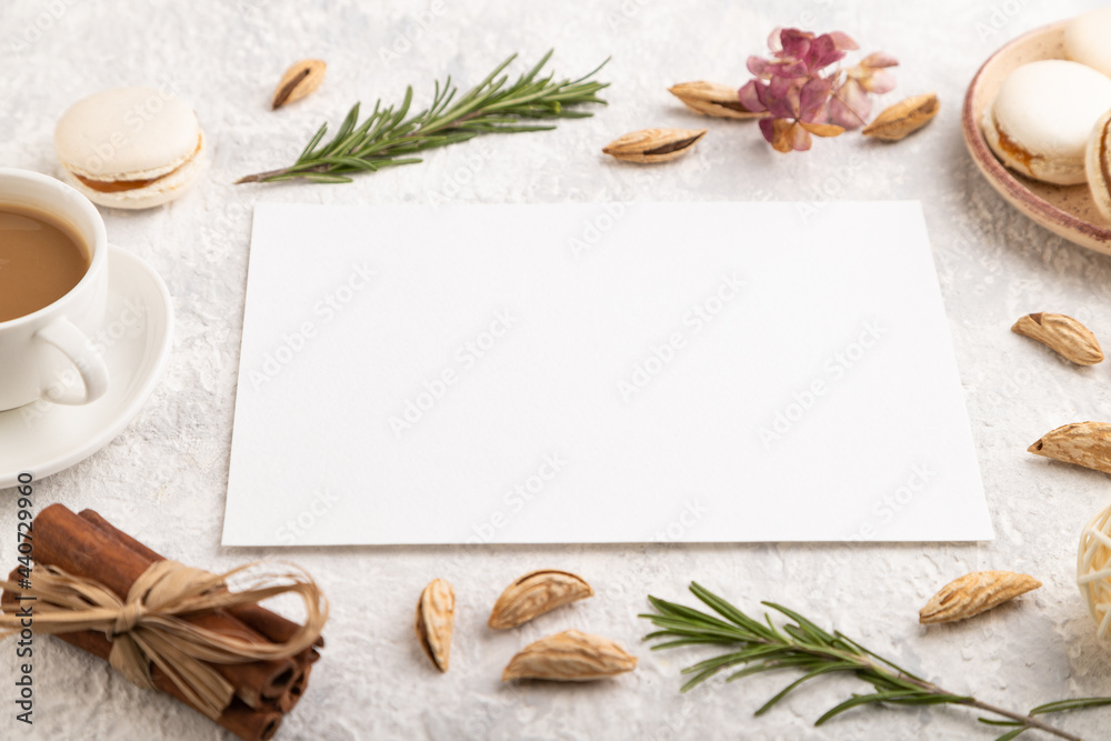 White paper sheet mockup with cup of coffee, almonds and macaroons on gray concrete background. business card, side view White paper sheet mockup with cup of coffee, almonds and macaroons on gray concrete background. business card, side view