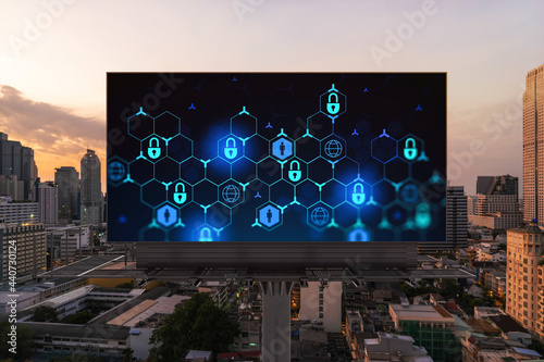 Padlock icon hologram on road billboard over panorama city view of Bangkok at sunset to protect business, Southeast Asia. The concept of information security shields. © VideoFlow