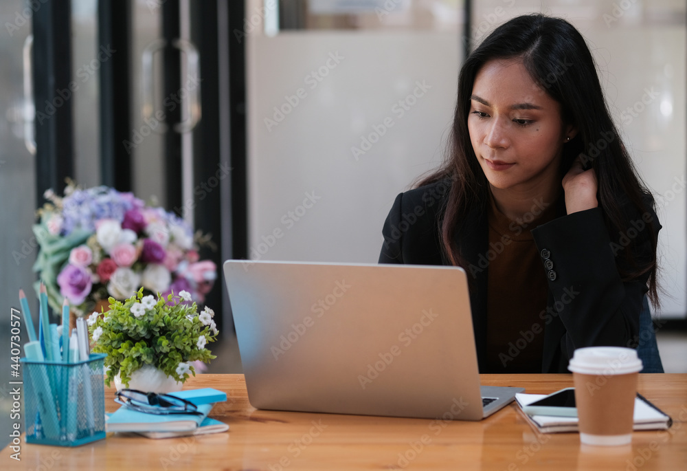 Front view with Asian business women working with her laptop, Working women concept. Front view with Asian business women working with her laptop, Working women concept.