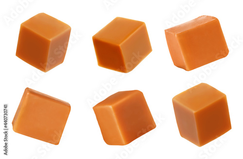 Set with delicious caramel candies on white background. Banner design photo