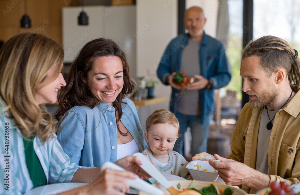 Fototapeta premium Happy multigeneration family indoors at home eating healthy lunch.