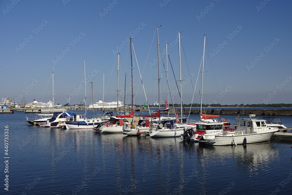 Seaview in the area of Maritime museum in Seaplane Harbour (in Estonian Lennusadam). Yachts and sailing boats on the dock. A sunny summer day with a clear blue sky. Tallinn, Estonia