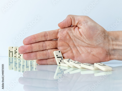 Cuadro en lienzo Hand stopping domino effect falling