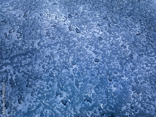 Abstract blurred background with water drops on blue.  Water drops on glass.  Water and shadows texture.  The concept of purity and freshness.