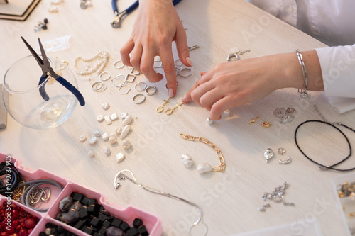 Fotótapéta Professional jewelry designer making handmade jewelry in studio workshop close up