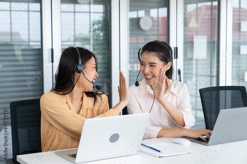 Telemarketer operators, Technical support use headset to call answer client questions and giving high five in a contact call center. Business telemarketing, Customer service, Communication telephone