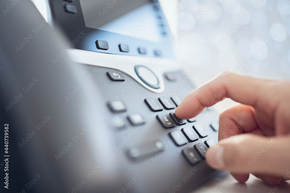 Dialing a telephone in the office concept for communication, contact us
