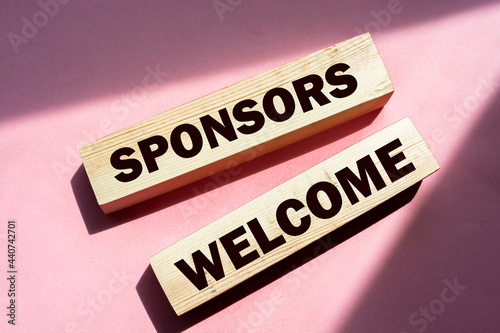 SPONSORS WELCOME on wooden blocks. Sponsorship donation support business startup concept.