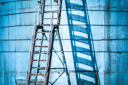 Ladder with access to a large tank in abandoned cargo terminal
