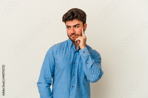 Young caucasian man isolated on white background contemplating, planning a strategy, thinking about the way of a business.
