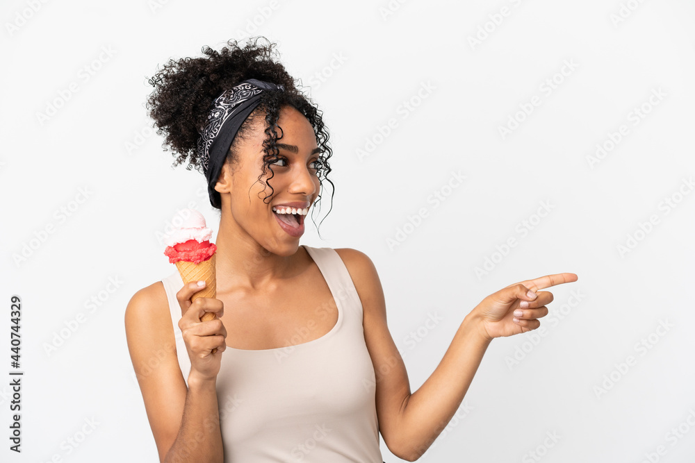 Young african american woman with a cornet ice cream isolated on white background pointing finger to the side and presenting a product Young african american woman with a cornet ice cream isolated on white background pointing finger to the side and presenting a product
