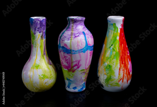 composition of three vases in an abstract style on a black background, modern art concept