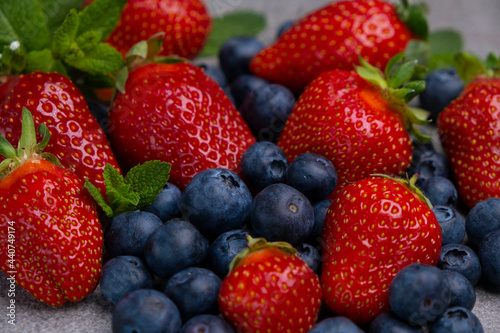 fresh strawberry and blueberry with leaves. Sweet ripe berries. Berry background. Healthy vegan food