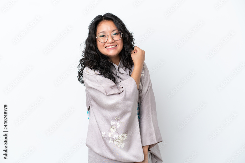Young asian woman wearing kimono isolated on white background celebrating a victory Young asian woman wearing kimono isolated on white background celebrating a victory