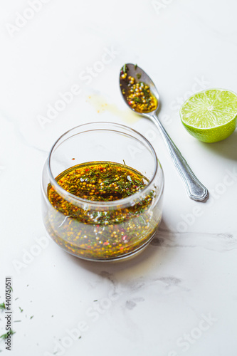 Mustard, olive oil and dill salad dressing in glass jar. Cooking healthy food concept. photo