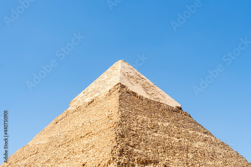 The high pyramid of Chephren on the background of a blue sky with clouds, Giza, Cairo, Egypt. second pyramid. Pyramid of Khafra. The upper part of the second great pyramid. pyramidon. photo