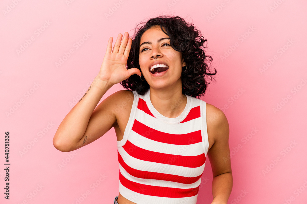 Young curly latin woman isolated on pink background joyful laughing a lot. Happiness concept. Young curly latin woman isolated on pink background joyful laughing a lot. Happiness concept.