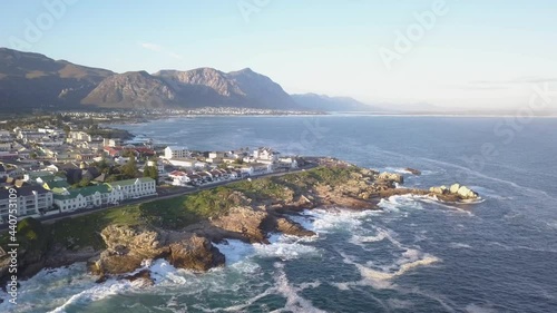 Aerial view over pretty seaside town with waves breaking on the coastline