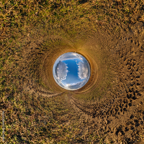 blue sky ball in middle of swirling sand road. Inversion of tiny planet transformation of spherical panorama 360 degrees. Curvature of space.