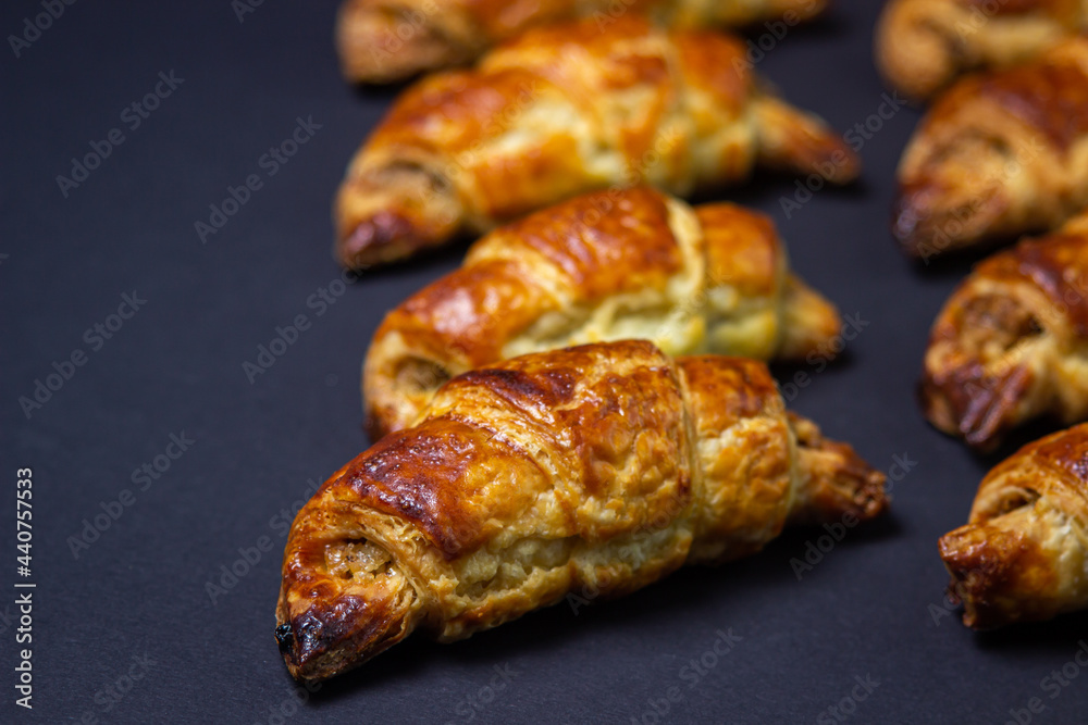 Walnut rolls on a black background. Homemade baking. Food background