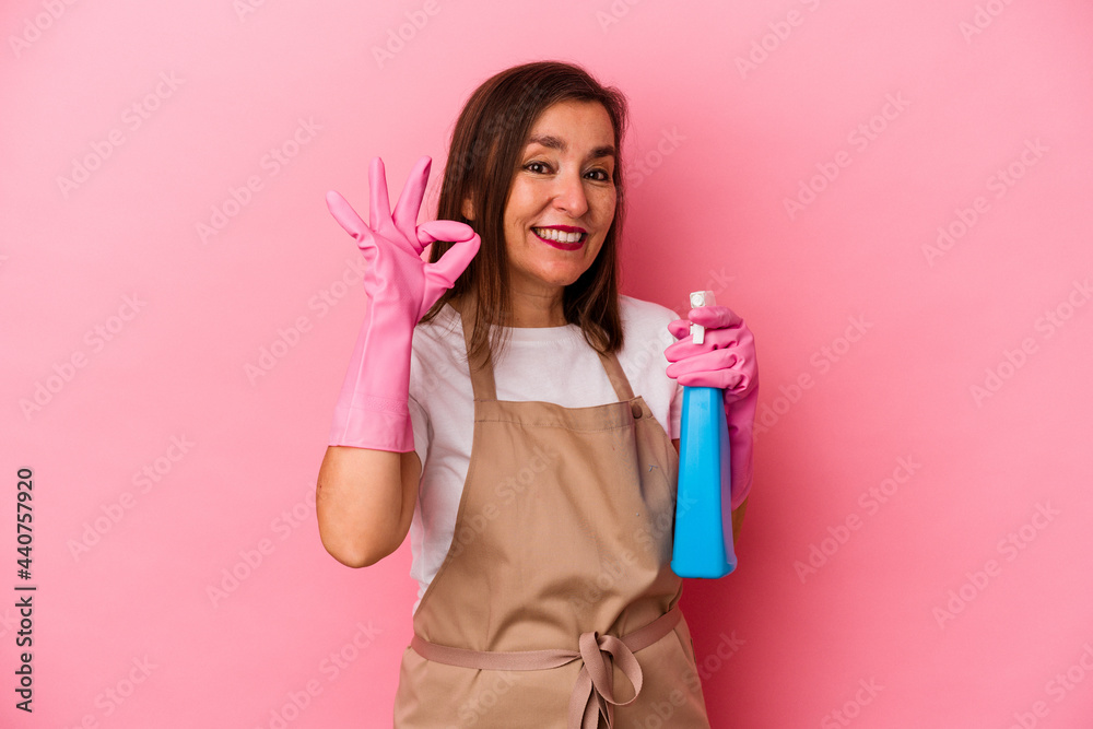 Middle age caucasian woman cleaning home isolated on pink background cheerful and confident showing ok gesture. Middle age caucasian woman cleaning home isolated on pink background cheerful and confident showing ok gesture.