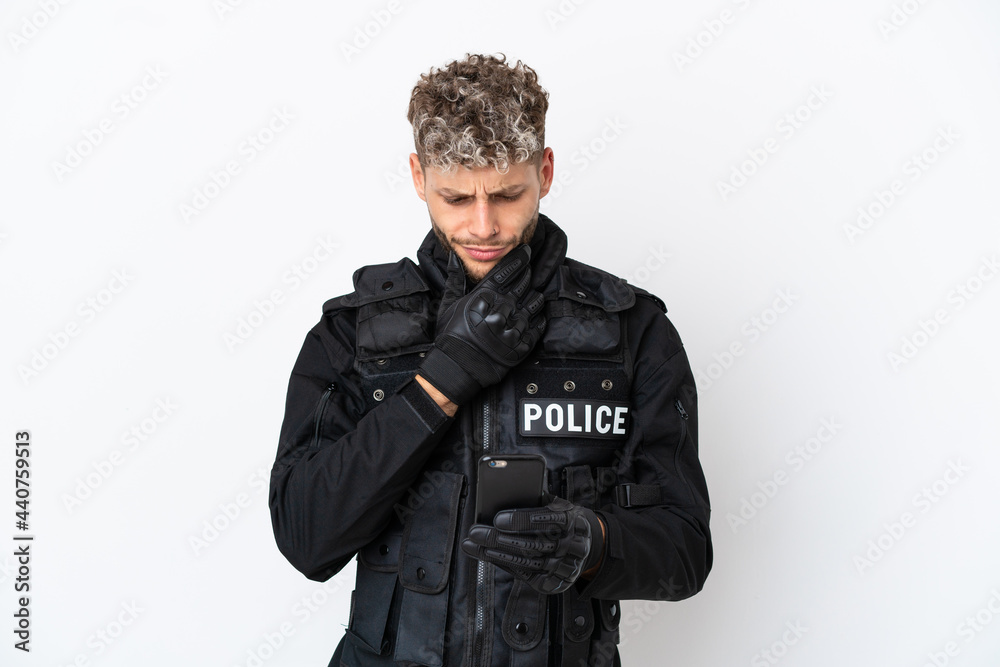 SWAT caucasian man isolated on white background thinking and sending a message SWAT caucasian man isolated on white background thinking and sending a message