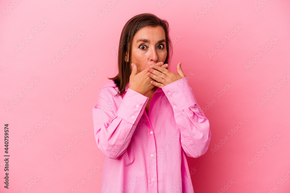 Middle age caucasian woman isolated on pink background shocked covering mouth with hands. Middle age caucasian woman isolated on pink background shocked covering mouth with hands.