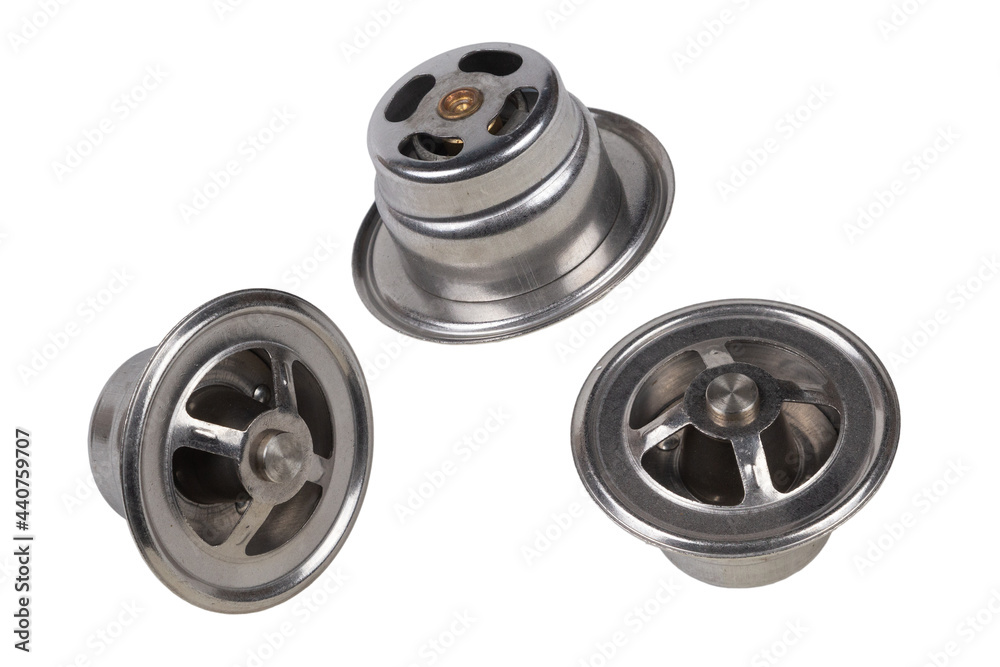 set of three thermostats of the truck engine cooling system. Spare parts on white background set of three thermostats of the truck engine cooling system. Spare parts on white background