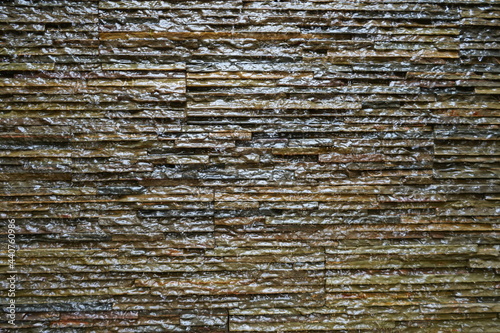 Brick wall with water flowing over.