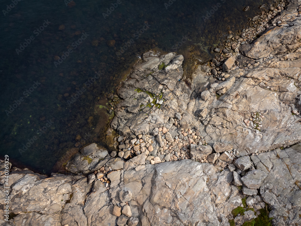 Fototapeta premium Bird's eye view of archipelago, coastline, cliffs and sea. Aerial, drone photography from above, northern Gothenburg in Sweden. Place for text, copy space.