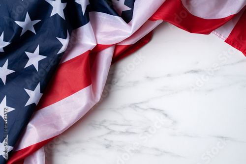 Concept of Independence day or Memorial day. Flag over bright marble table background.