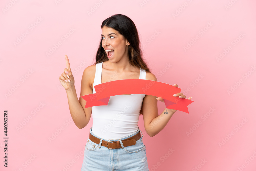 Young caucasian woman isolated on pink background holding an empty placard and thinking Young caucasian woman isolated on pink background holding an empty placard and thinking