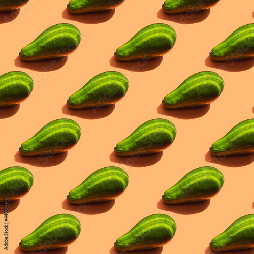 A pattern of ripe green avocado with shadow and stripes from the light