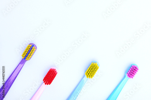 Assortment of brushes for cleaning teeth. Multi-colored toothbrushes. Oral hygiene. Copy space. View from above.